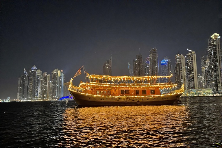Dhow Cruise Illuminated with Lights Against Dubai Marina Skyline